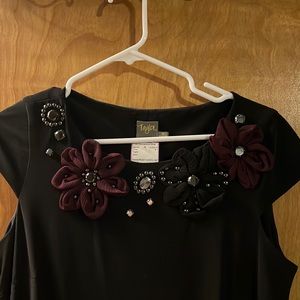 Little black dress with flower and bead detail.